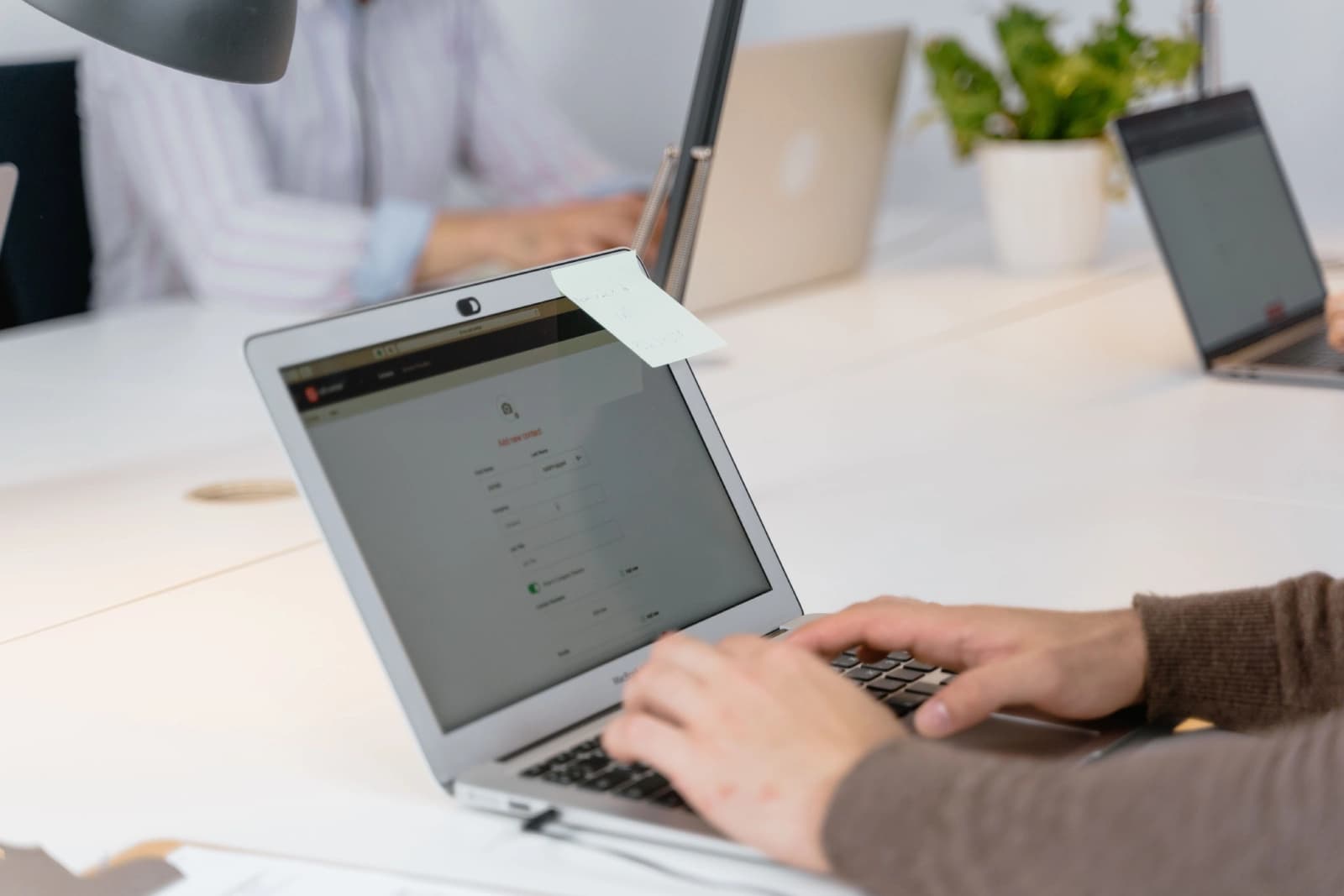 Person filling out a form on laptop during verification process